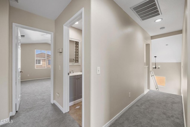834 Corte Baya Vis, Oxnard, CA 93030 - corridor featuring visible vents, a sink, baseboards, an upstairs landing, and light carpet