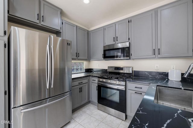 834 Corte Baya Vis, Oxnard, CA 93030 - kitchen featuring light tile patterned flooring, appliances with stainless steel finishes, gray cabinets, dark stone counters, and recessed lighting