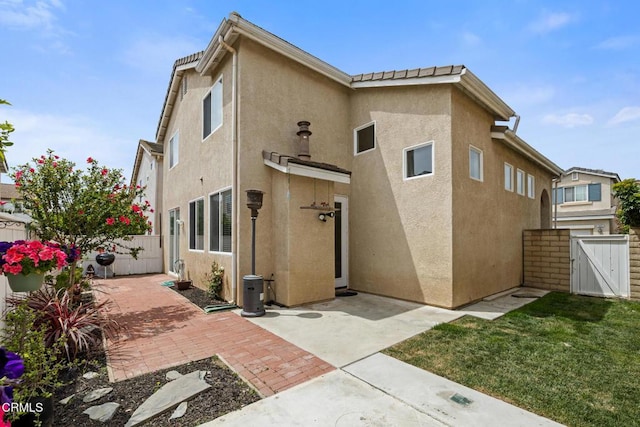 834 Corte Baya Vis, Oxnard, CA 93030 - rear view of property with a fenced backyard, a gate, a patio, and stucco siding