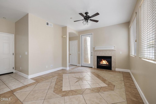 834 Corte Baya Vis, Oxnard, CA 93030 - unfurnished living room with visible vents, a fireplace, baseboards, a ceiling fan, and light tile patterned floors