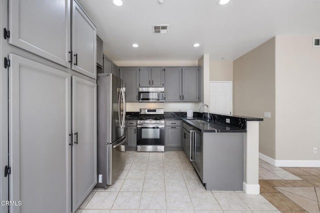 834 Corte Baya Vis, Oxnard, CA 93030 - kitchen featuring a peninsula, gray cabinets, appliances with stainless steel finishes, and dark countertops
