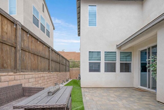 1662 Whitmore Loop, Chula Vista, CA 91913 - view of home's exterior with a fenced backyard, stucco siding, and a patio area