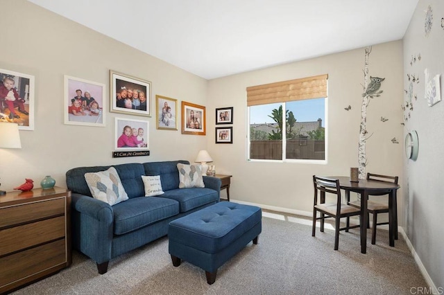 living room featuring carpet flooring and baseboards