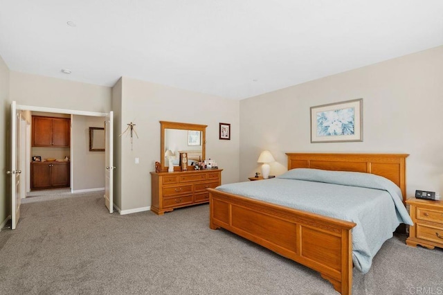 bedroom featuring light colored carpet and baseboards