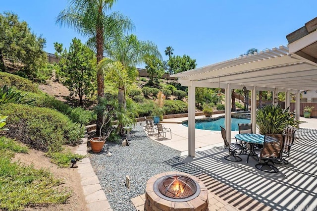 pool featuring an outdoor fire pit, a patio area, and a pergola