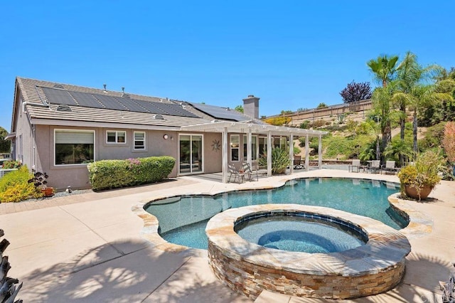 view of swimming pool featuring a pergola, a pool with connected hot tub, and a patio