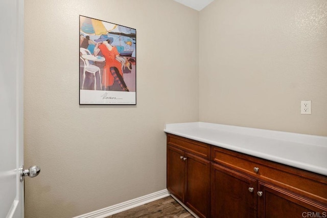 bathroom featuring baseboards and wood finished floors