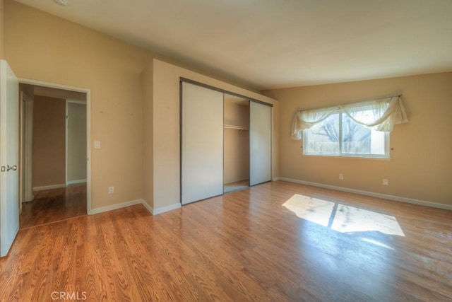 24731 Huntley Dr, Moreno Valley, CA 92557 - unfurnished bedroom featuring a closet, baseboards, and wood finished floors