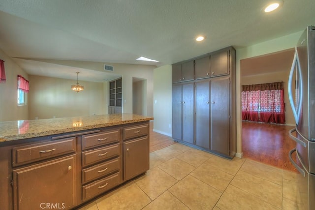 24731 Huntley Dr, Moreno Valley, CA 92557 - kitchen featuring visible vents, light tile patterned floors, freestanding refrigerator, a notable chandelier, and recessed lighting