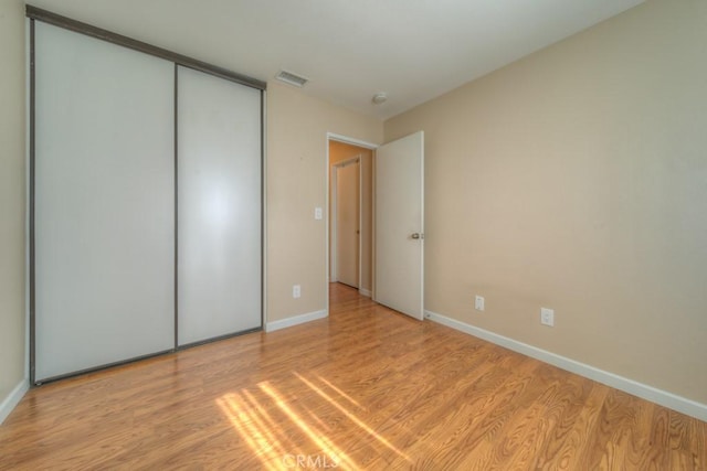 24731 Huntley Dr, Moreno Valley, CA 92557 - unfurnished bedroom featuring a closet, baseboards, visible vents, and light wood-style floors