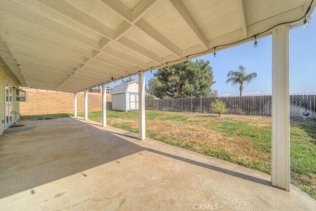 24731 Huntley Dr, Moreno Valley, CA 92557 - view of patio / terrace with a fenced backyard, an outbuilding, and a storage shed