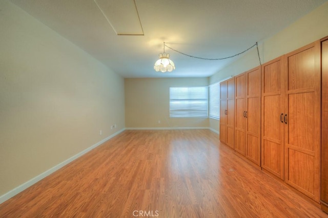 24731 Huntley Dr, Moreno Valley, CA 92557 - unfurnished bedroom with baseboards and light wood-style flooring