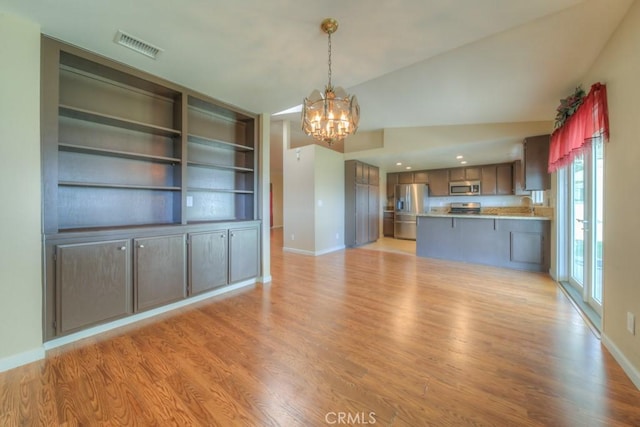 24731 Huntley Dr, Moreno Valley, CA 92557 - unfurnished living room with baseboards, light wood-style floors, a chandelier, and visible vents