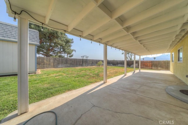 24731 Huntley Dr, Moreno Valley, CA 92557 - view of patio / terrace with a fenced backyard, an outbuilding, and a storage shed