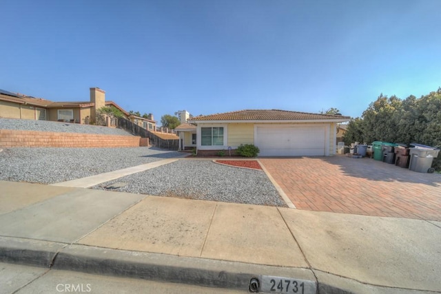 24731 Huntley Dr, Moreno Valley, CA 92557 - single story home with a garage, a tiled roof, and driveway
