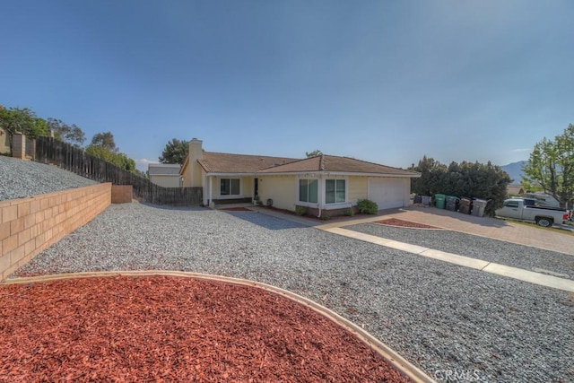 24731 Huntley Dr, Moreno Valley, CA 92557 - ranch-style home with fence private yard, a garage, driveway, and a chimney