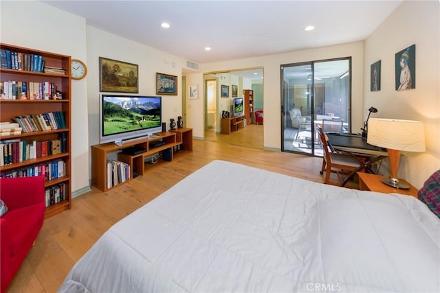 bedroom with visible vents, recessed lighting, and wood finished floors