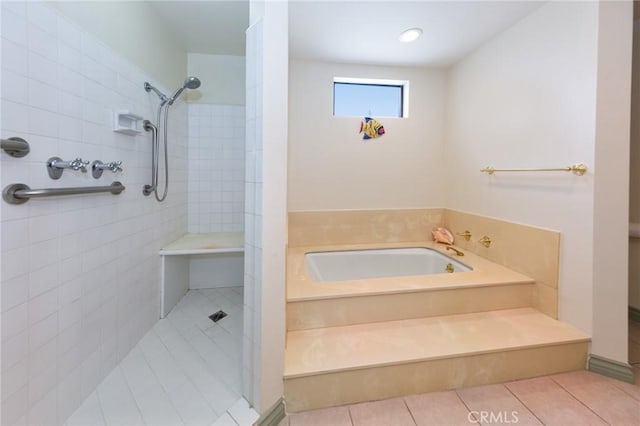full bathroom featuring tile patterned flooring, a garden tub, and a tile shower