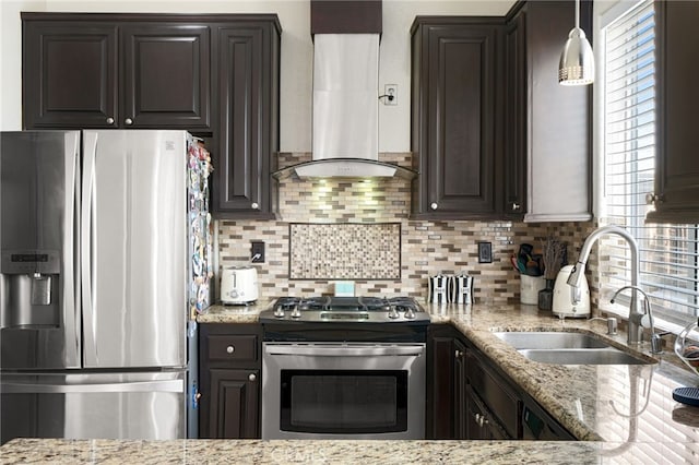 kitchen featuring a sink, backsplash, wall chimney range hood, and stainless steel appliances