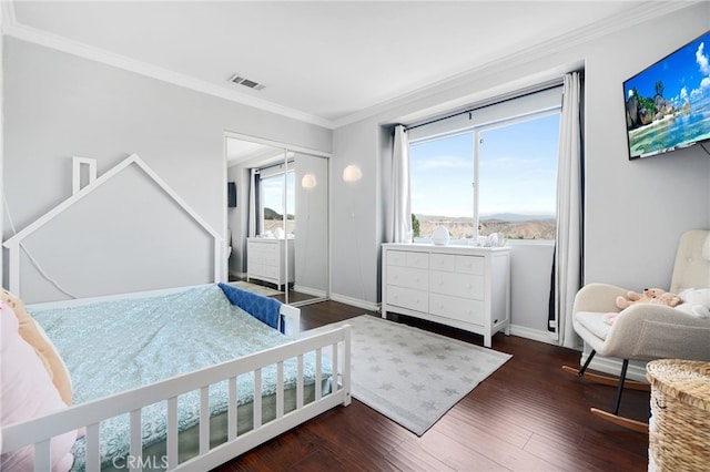 bedroom with visible vents, baseboards, crown molding, and dark wood-style floors