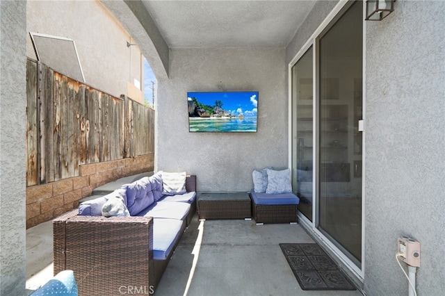 view of patio with outdoor lounge area and fence