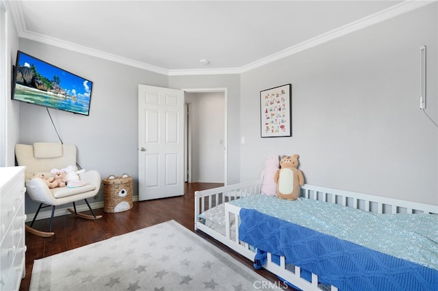 bedroom featuring crown molding, baseboards, and wood finished floors