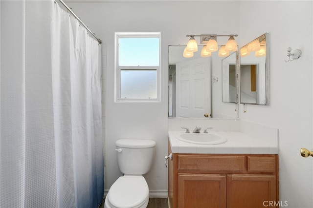 bathroom featuring vanity, a shower with shower curtain, and toilet