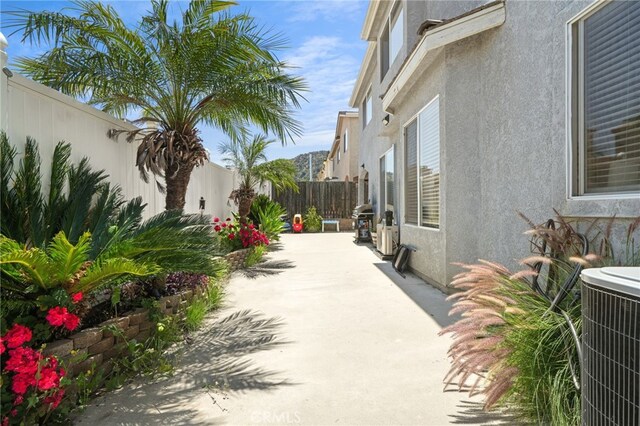 view of patio featuring a fenced backyard and central AC