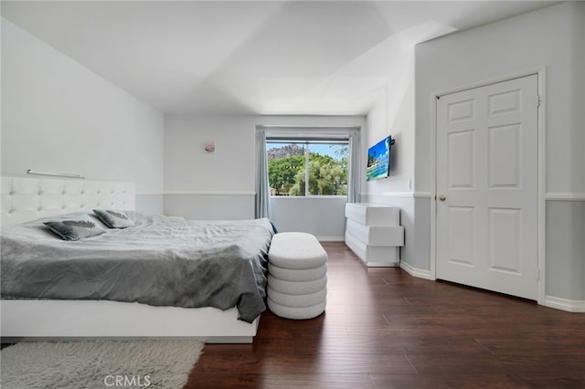 bedroom featuring baseboards and wood finished floors