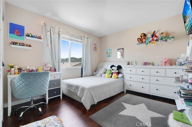 bedroom with dark wood-type flooring