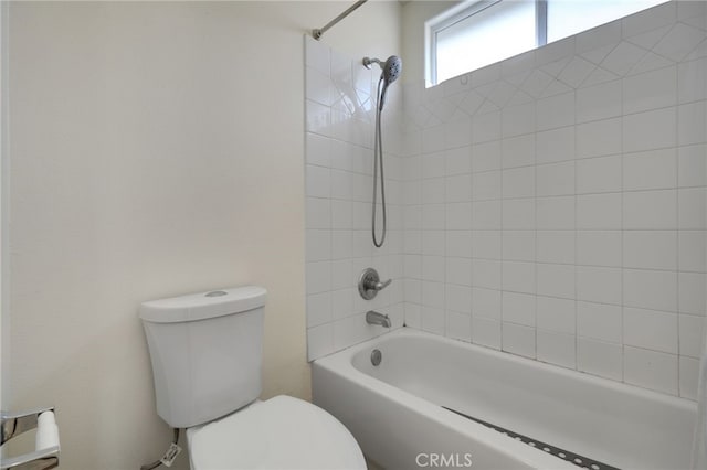 bathroom featuring shower / bathtub combination and toilet