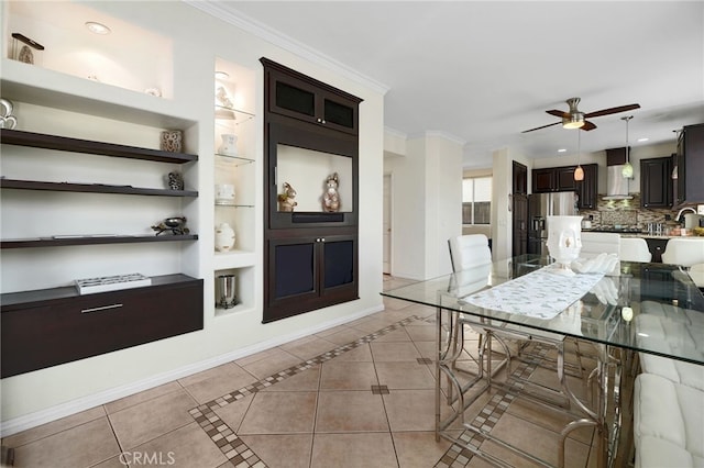dining room with crown molding, a ceiling fan, built in features, and light tile patterned flooring
