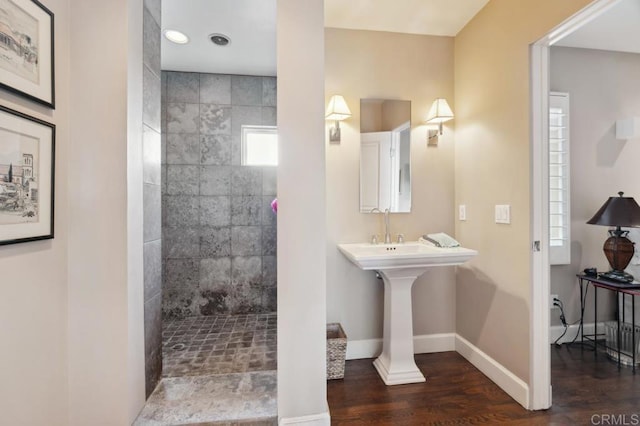 full bath featuring baseboards, walk in shower, and wood finished floors