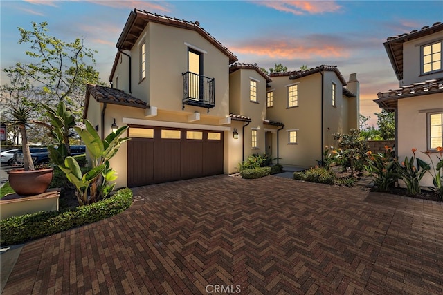 207 Via Galicia, San Clemente, CA 92672 - mediterranean / spanish house with a balcony, a tile roof, an attached garage, decorative driveway, and stucco siding