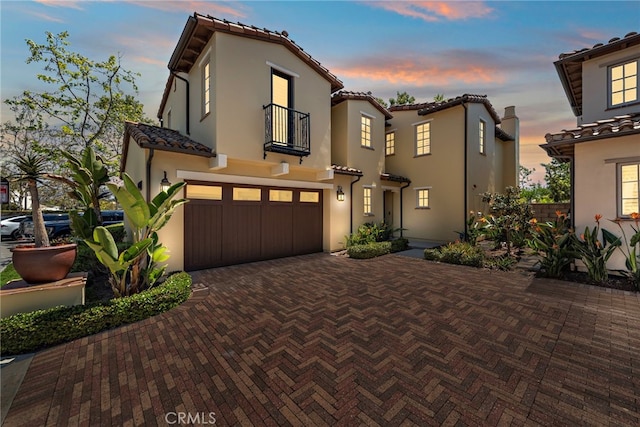 207 Via Galicia, San Clemente, CA 92672 - mediterranean / spanish home featuring a balcony, a garage, decorative driveway, a tiled roof, and stucco siding