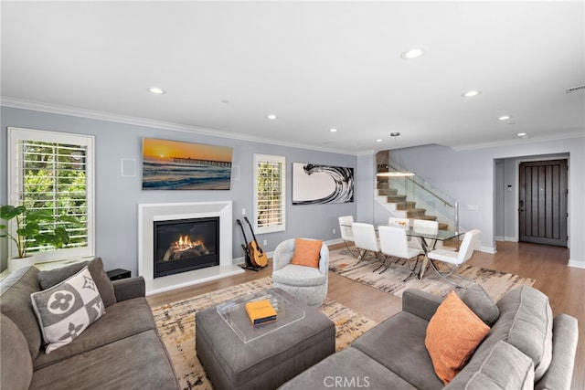 207 Via Galicia, San Clemente, CA 92672 - living room with a glass covered fireplace, recessed lighting, ornamental molding, stairs, and wood finished floors