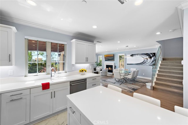 207 Via Galicia, San Clemente, CA 92672 - kitchen featuring recessed lighting, a warm lit fireplace, open floor plan, stainless steel dishwasher, and ornamental molding