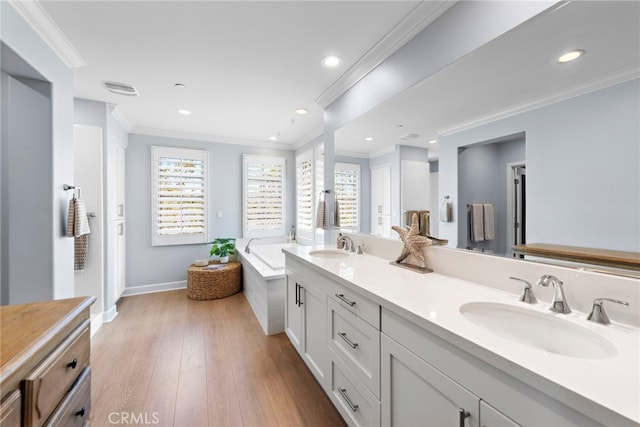 207 Via Galicia, San Clemente, CA 92672 - bathroom featuring double vanity, a bath, ornamental molding, wood finished floors, and recessed lighting