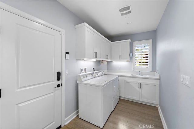 207 Via Galicia, San Clemente, CA 92672 - laundry room with washing machine and dryer, cabinet space, and light wood-style floors