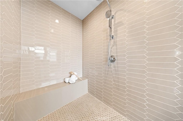 full bath featuring tile walls and tiled shower