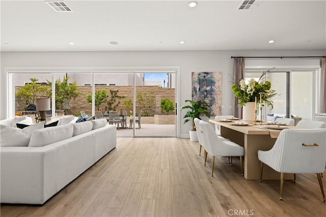 living room featuring recessed lighting, visible vents, and light wood-style flooring