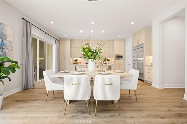dining space featuring recessed lighting, baseboards, and light wood-style floors