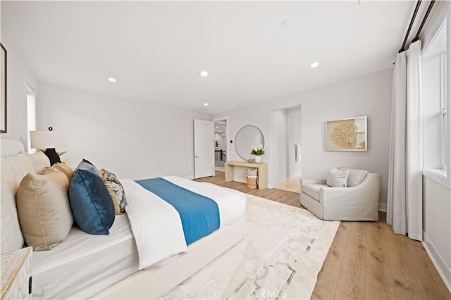 bedroom with light wood-type flooring, recessed lighting, and baseboards