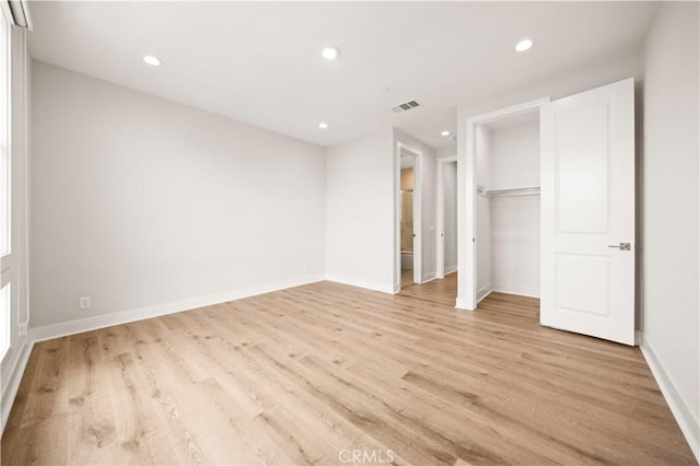 unfurnished bedroom featuring recessed lighting, baseboards, light wood-type flooring, visible vents, and a closet