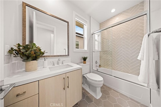 bathroom with vanity, enclosed tub / shower combo, toilet, and tile patterned flooring