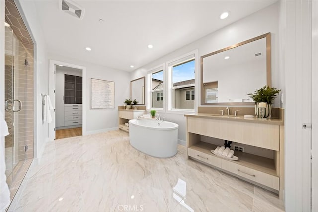 bathroom featuring vanity, marble finish floor, a stall shower, and a soaking tub