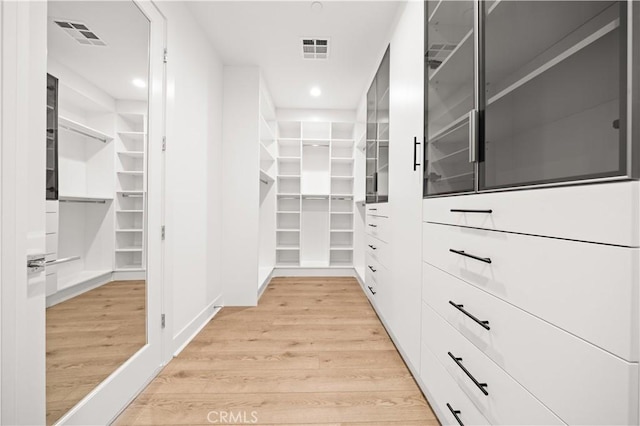 walk in closet with visible vents and light wood-style floors