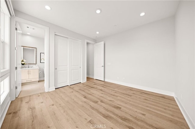 271 Huckleberry, Lake Forest, CA 92630 - unfurnished bedroom featuring light wood-style floors, ensuite bathroom, baseboards, and recessed lighting