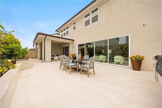 271 Huckleberry, Lake Forest, CA 92630 - rear view of property with outdoor dining space, a patio, stucco siding, and fence