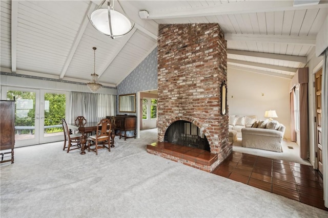 interior space featuring a fireplace, french doors, beam ceiling, and a chandelier